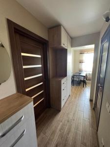 a kitchen with a closet with a door and a table at Gerasima Kondratyeva 152 in Sumy +2 photos