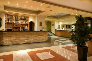 a lobby of a hotel with a bar at Philoxenia in Kavála