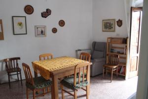 a dining room with a table and chairs and a couch at Nonno Sandro in Tursi