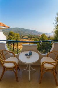 a table and chairs on a balcony with a view at Philoxenia in Kavala