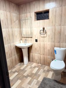 a bathroom with a toilet and a sink at ToonToonik in Hors