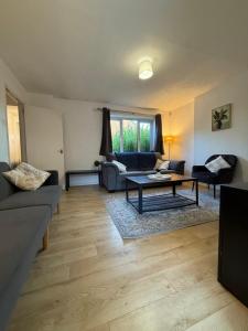 a living room with a couch and a table at Relaxing Home in Bradley Stoke in Bristol +11 photos