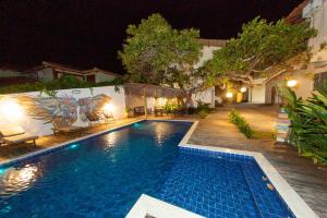 a swimming pool in a yard at night at Recanto do villa 2 in Trancoso