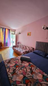 a bedroom with two beds and a rug on the floor at ASINE Dilijan in Dilijan