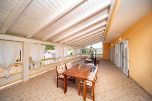 a balcony with a wooden table and chairs at Apartments Spomenka in Mundanije