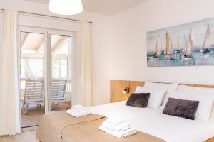 a bedroom with two beds and a table with chairs at Apartments Spomenka in Mundanije +77 photos
