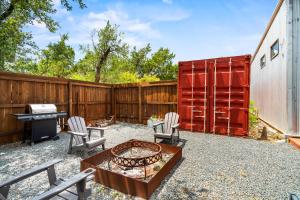 a backyard with a fire pit and a fence at Contemporary 3BR Country Gem Swim Spa & Fire Pit in Dripping Springs +52 photos