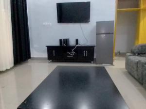a living room with a television and a couch at Volcano homes in Ruhengeri