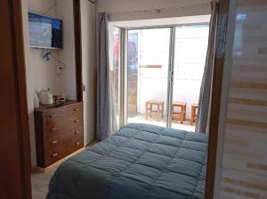a bedroom with a bed and a sliding glass door at Lomas San Andres in El Cerrillo