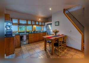 a kitchen with a table with chairs and a sink at Love Nest Atitlán in Panajachel
