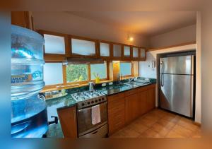 a kitchen with a bottle of water on the counter at Love Nest Atitlán in Panajachel +7 photos