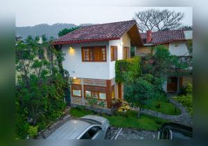 a house with a car parked in front of it at Love Nest Atitlán in Panajachel