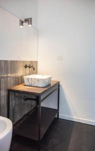a bathroom with a sink and a mirror at Regina Margherita Luxury House in Modica