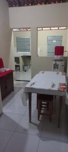 a kitchen with a table in the middle of a room at Casa de Lagoa Nova in Martins