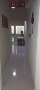 a hallway with a table in the middle of a room at Casa de Lagoa Nova in Martins +2 photos