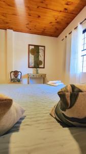una camera da letto con un letto grande con soffitto in legno di Alojamiento en Puerto Iguazú, Alojamiento en Cataratas, 2 Habitaciones a Puerto Iguazú Altre 3 foto