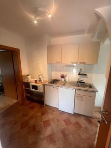 a small kitchen with white cabinets and a sink at Central Home in Salzburg +15 photos