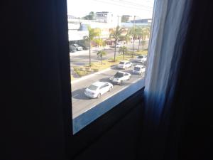 a view from a window of a street with cars at Apartamento Ferias e Tarabalho in Vila Velha
