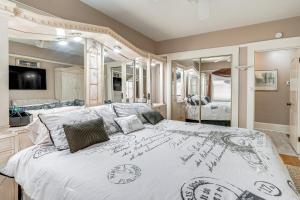 a bedroom with a large bed with a large mirror at Miracle Mile Stay Classic Stockton Home with Yard! in Stockton