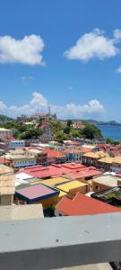 a view of a city with colorful roofs at Oceanview Suites in Saint Georgeʼs