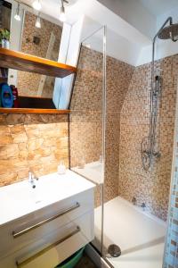 a bathroom with a shower and a sink at Little paradise house in Lič