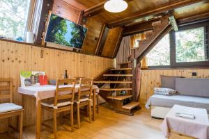 a room with a dining table and a tv on the wall at Little paradise house in Lič