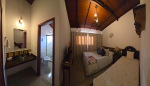 a small bedroom with a bed and a bathroom at Pousada Boutique Chico Anjo in Ouro Preto +54 photos