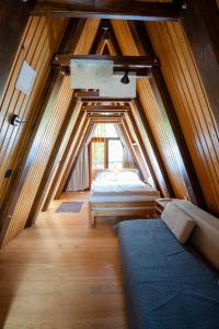 a small attic bedroom with two beds in it at Little paradise house in Lič