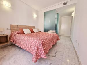 a bedroom with a large bed with a red blanket at APARTAMENTO MORAIRA - 3 Habitaciones in Moraira