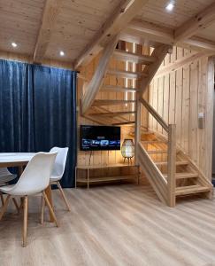 a room with a staircase and a table and chairs at Mazurski Chill House in Małkinie +13 photos