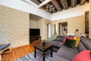 a living room with a couch and a table at 15th Century Flat with Parking, High Ceilings in Tallinn