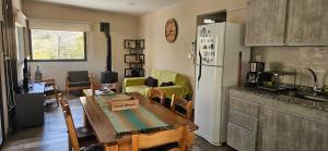 a kitchen and living room with a table and a refrigerator at Entre Montañas - Vista Calma in Potrerillos +19 photos
