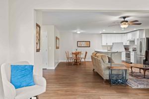 a living room with a couch and a table at Stone's Throw by Mirror Lake in Highlands