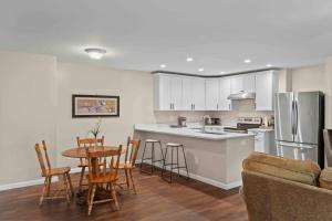 a kitchen and living room with a table and chairs at Stone's Throw by Mirror Lake in Highlands