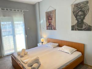 a bedroom with a large bed with towels on it at Downtown Hostel AXD in Alexandroupoli