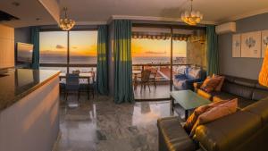 a living room with a couch and a view of the ocean at Apartamento Lago Panoramic Ocean Views in Puerto de Santiago +10 photos