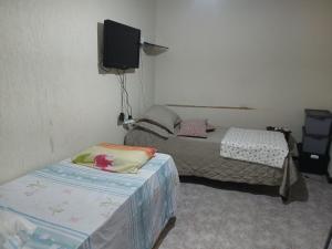 Ένα ή περισσότερα κρεβάτια σε δωμάτιο στο SUITE NA BARRINHa