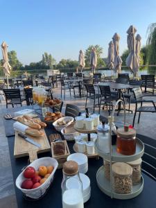 a table with food on it with tables and chairs at L'ile chaumette in Épervans +38 photos