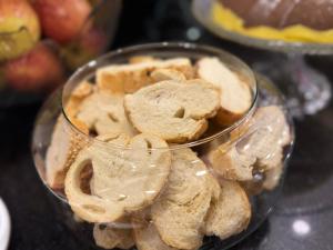a glass bowl filled with cookies on a table at Hotel Haven Guarulhos in Guarulhos +40 photos