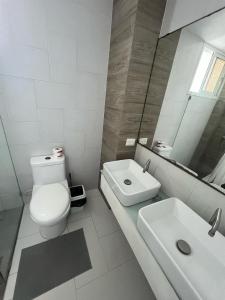 a white bathroom with a toilet and a sink at residenziale sol Beach pool Punta Cana in Punta Cana