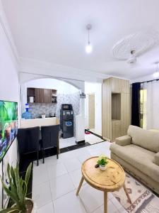 a living room with a couch and a table at Bamburi Getaway Studio in Mombasa