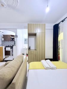 a living room with a bed and a couch at Bamburi Getaway Studio in Mombasa