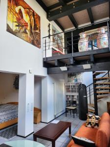 a living room with a loft with a staircase at Art in Nature in Münzenberg