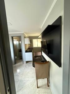 een woonkamer met een tafel en een stoel bij Confort Flat Campina Grande in Campina Grande