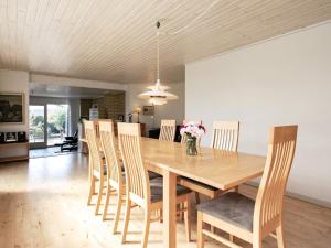 a dining room with a wooden table and chairs at 8 person holiday home in Skagen in Skagen