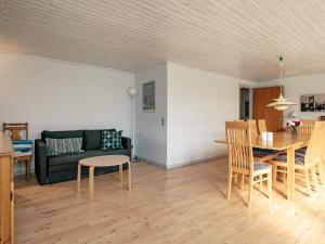 a living room with a couch and a table at 8 person holiday home in Skagen in Skagen