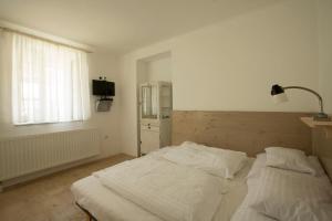 Posteľ alebo postele v izbe v ubytovaní Plitzner Belvárosi Apartmanház