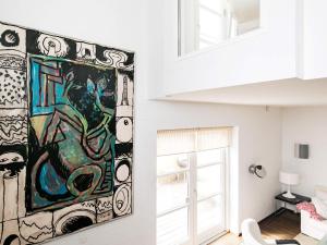 a painting hanging on a wall in a room at 4 star holiday home in Skagen in Skagen +27 photos
