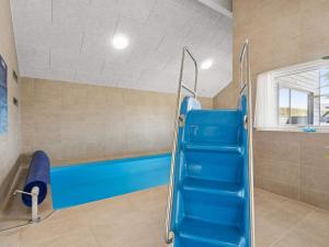 a gym with a blue bench in a room at 5 star holiday home in Bogense in Bogense