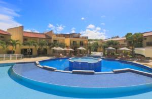 a large swimming pool in front of a resort at Flat Palmeira-Pipa Solar - centro in Tibau do Sul +5 photos